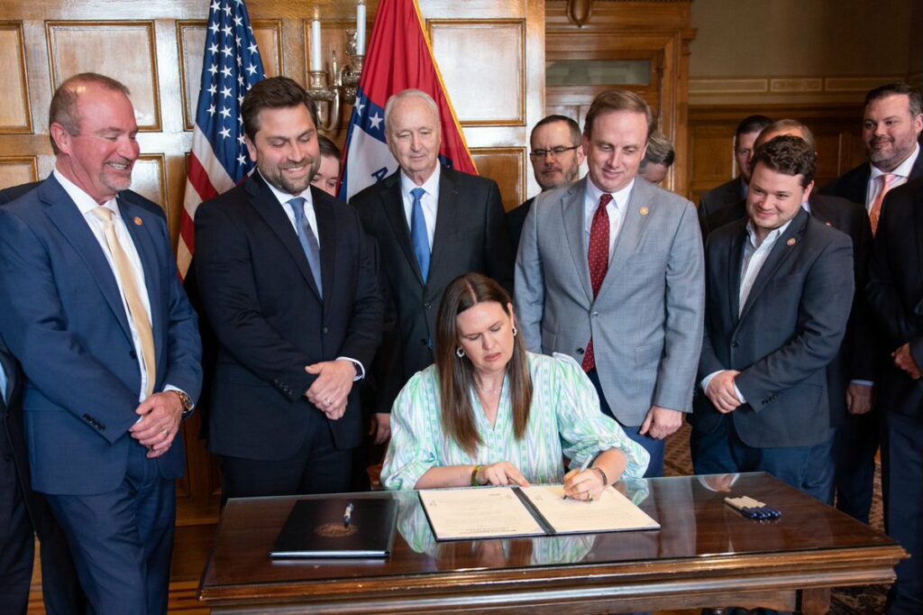 Republican Gov. Sarah Huckabee Sanders signed into law a measure cutting individual and corporate income taxes in Arkansas by $124 million a year.