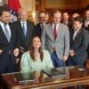 Republican Gov. Sarah Huckabee Sanders signed into law a measure cutting individual and corporate income taxes in Arkansas by $124 million a year.