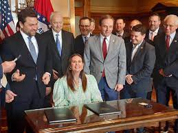 Republican Gov. Sarah Huckabee Sanders signed into law a measure cutting individual and corporate income taxes in Arkansas by $124 million a year.